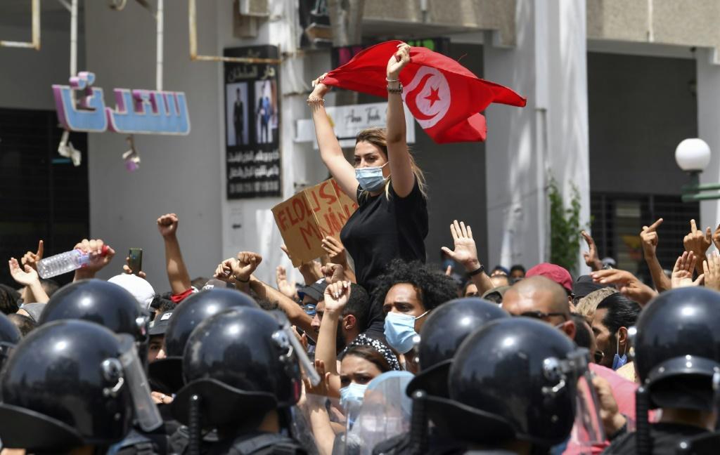 a-tunisian-protester-waves-the-national-flag-at